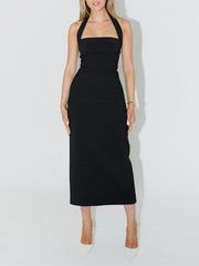 Front view of black halter neck bodycon midi dress on model in studio
