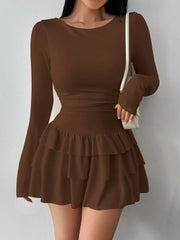 Coffee layered ruffle long sleeve mini dress worn front facing with a white shoulder bag