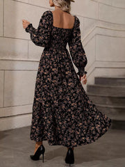 Back view of black floral midi dress with open square back and flowing skirt