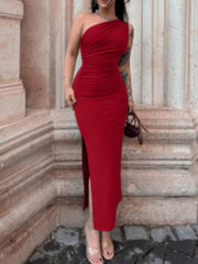 Model wearing deep red one shoulder ruched bodycon slit dress, front view outdoors