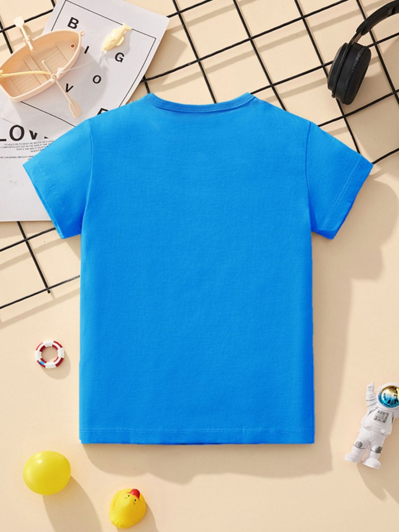 Back view of a plain sky blue children's short sleeve t-shirt laid flat