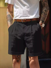 Men's black classic pleated shorts with pockets, available in plus sizes.