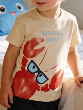 Children's apricot round neck tee worn in front view with large red lobster wearing glasses