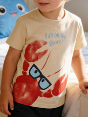 Children's apricot round neck tee worn in front view with large red lobster wearing glasses
