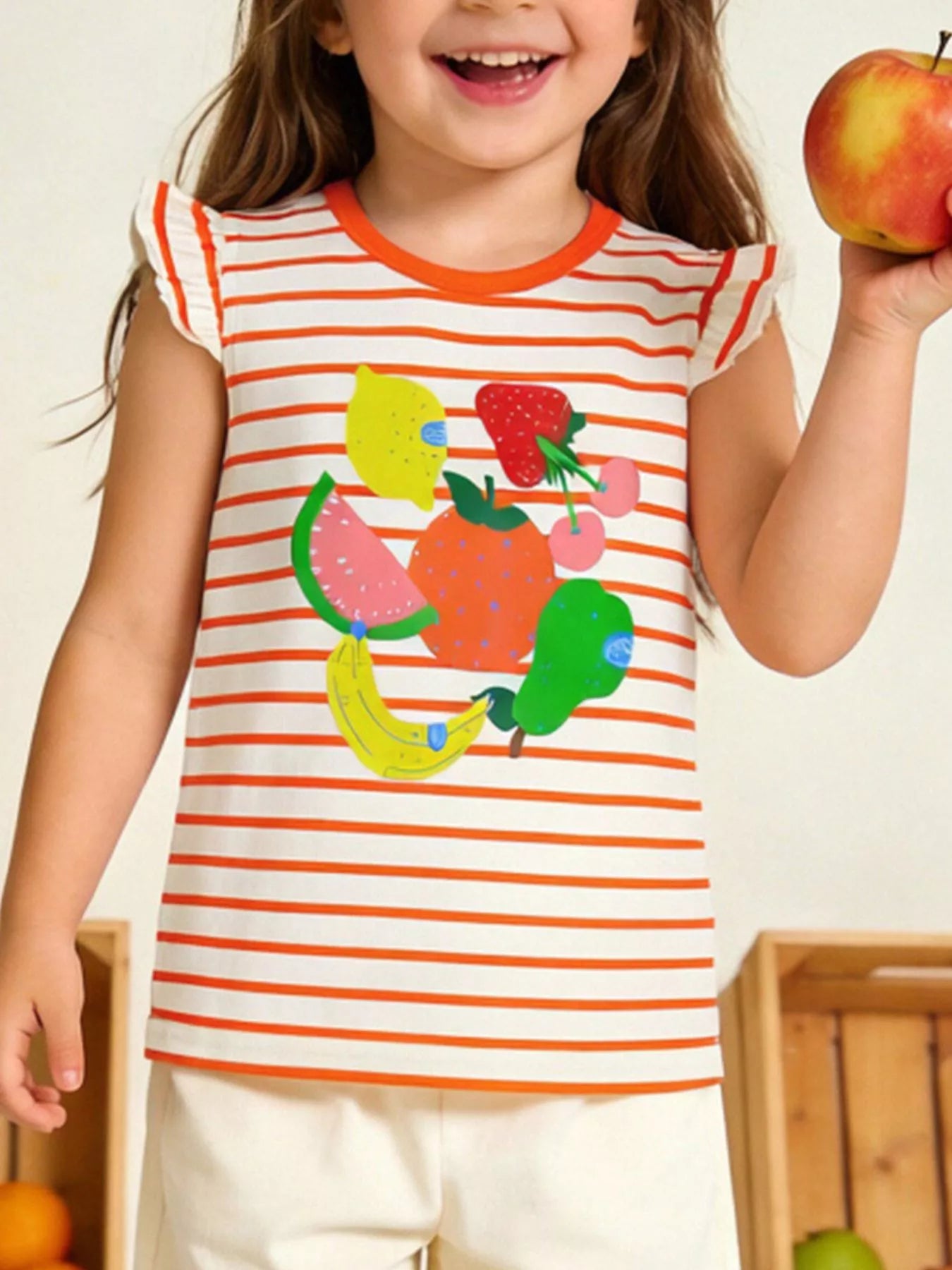 Orange and white striped children's tee with a colourful fruit print and ruffle sleeves, shown worn