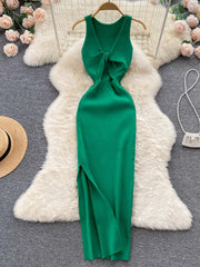 Emerald green sleeveless knit bodycon midi dress, back view with knotted open back on hanger