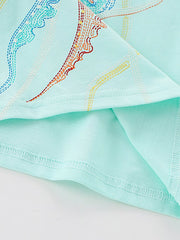 Close-up of jellyfish tentacles and hem stitching on mint blue children's t-shirt