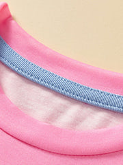 Close-up of the pink round neckline with a light blue inner trim and stitching