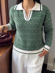 On-model front view of a green and white geometric patterned sweater with a white collar