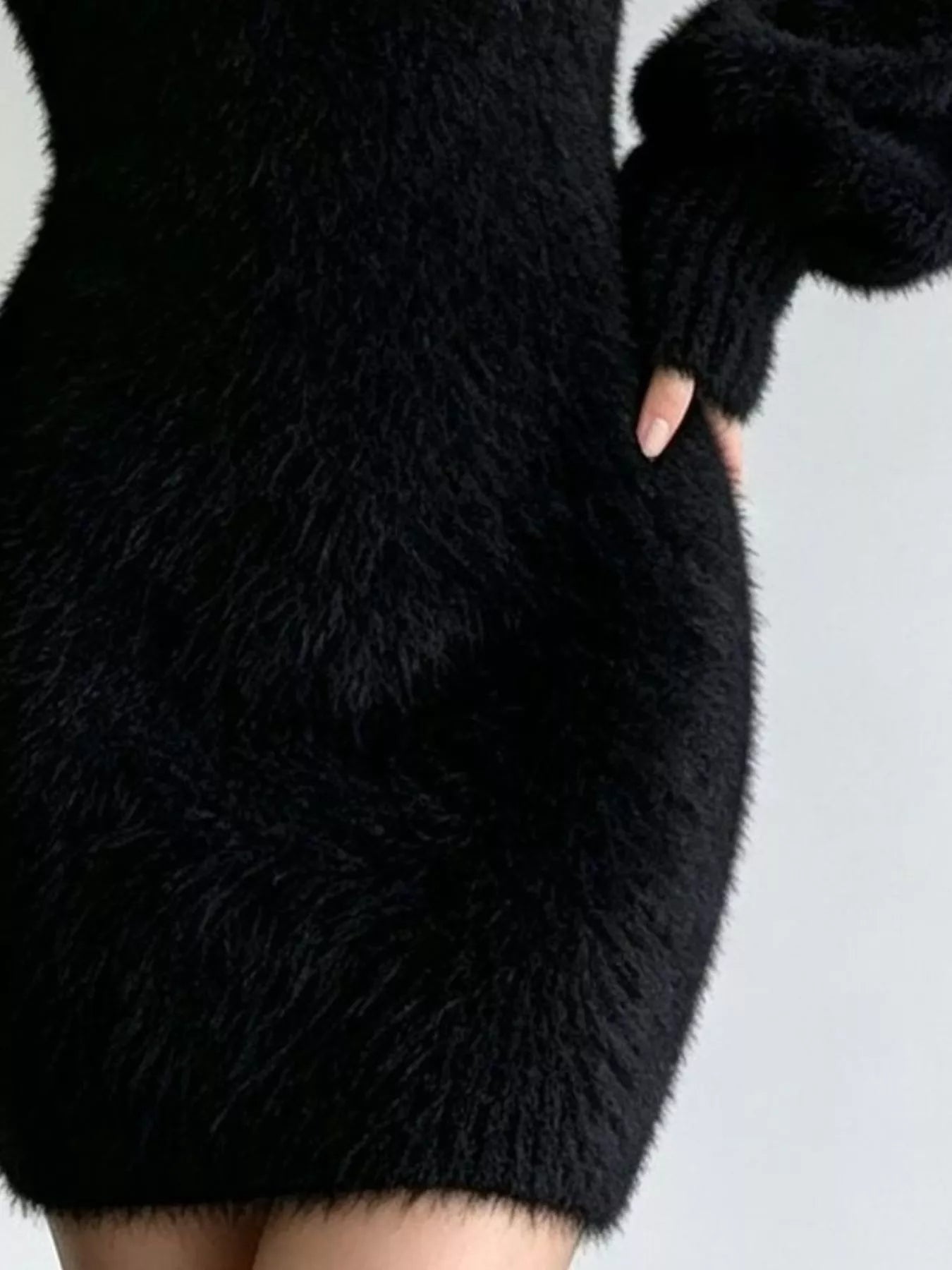 Black fuzzy knit sweater dress, close side view of ribbed cuff and knit texture