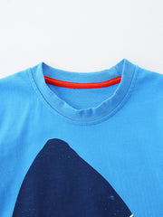 Close up of sky blue children's t-shirt round neckline with red inner trim stitching