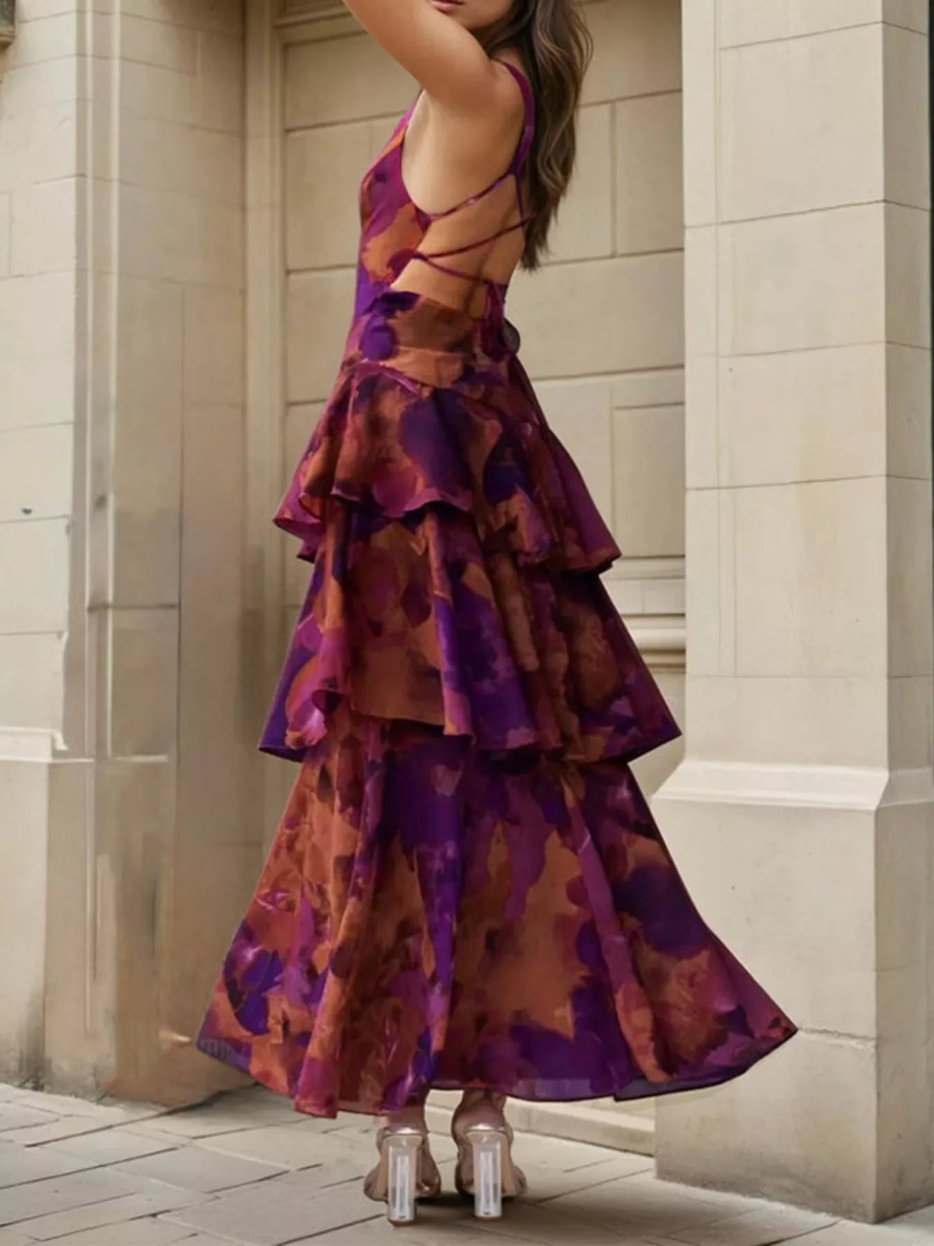 Back view of a deep purple floral maxi dress with an open lace up back and tiered ruffles