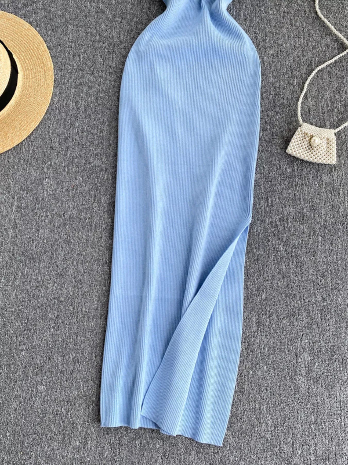 Lower skirt of light blue ribbed knit midi dress showing side slit detail