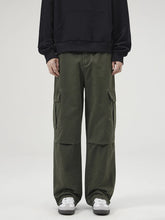 Men's loose-fit cargo pants with pockets in the Matcha Green color.