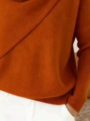 Close-up of the burnt orange sweater lower body and long sleeve showing the ribbed hem and knit texture