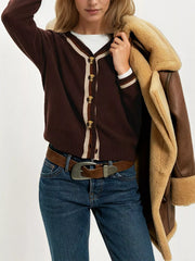 On-model front view of brown button down cardigan with cream and brown striped trim layered over white top