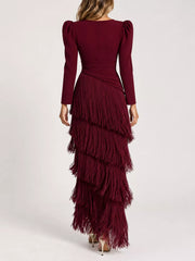 Studio back view of a burgundy fringed maxi dress with tiered fringe layers