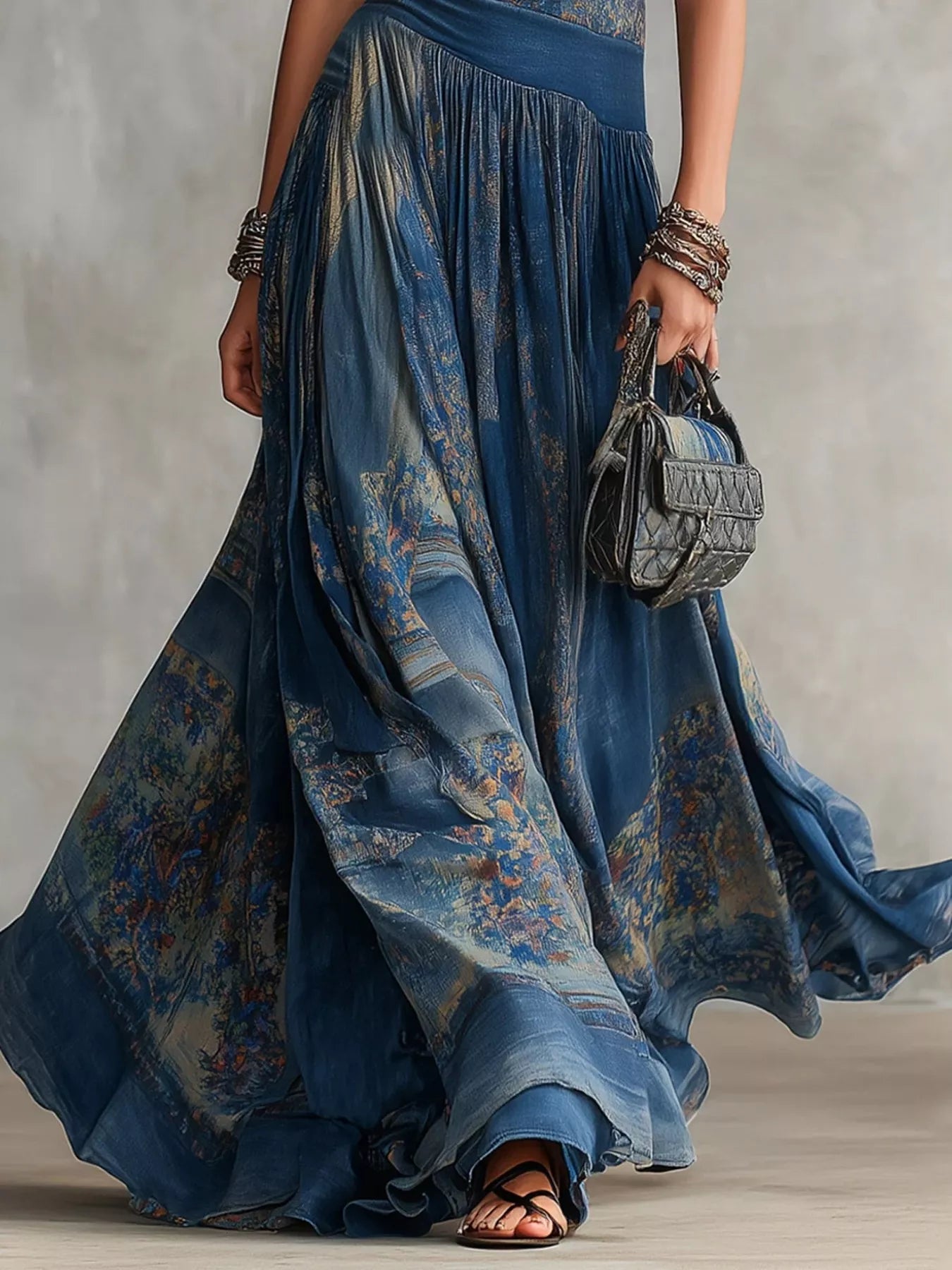 Lower skirt detail of dusty blue printed sleeveless maxi dress showing flowing patterned fabric