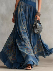 Lower skirt detail of dusty blue printed sleeveless maxi dress showing flowing patterned fabric
