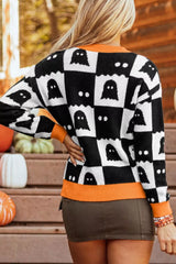 Back view of a black and white checkerboard sweater with orange hem and cuffs