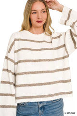 Front view of cream and mocha striped sweater with one sleeve raised.