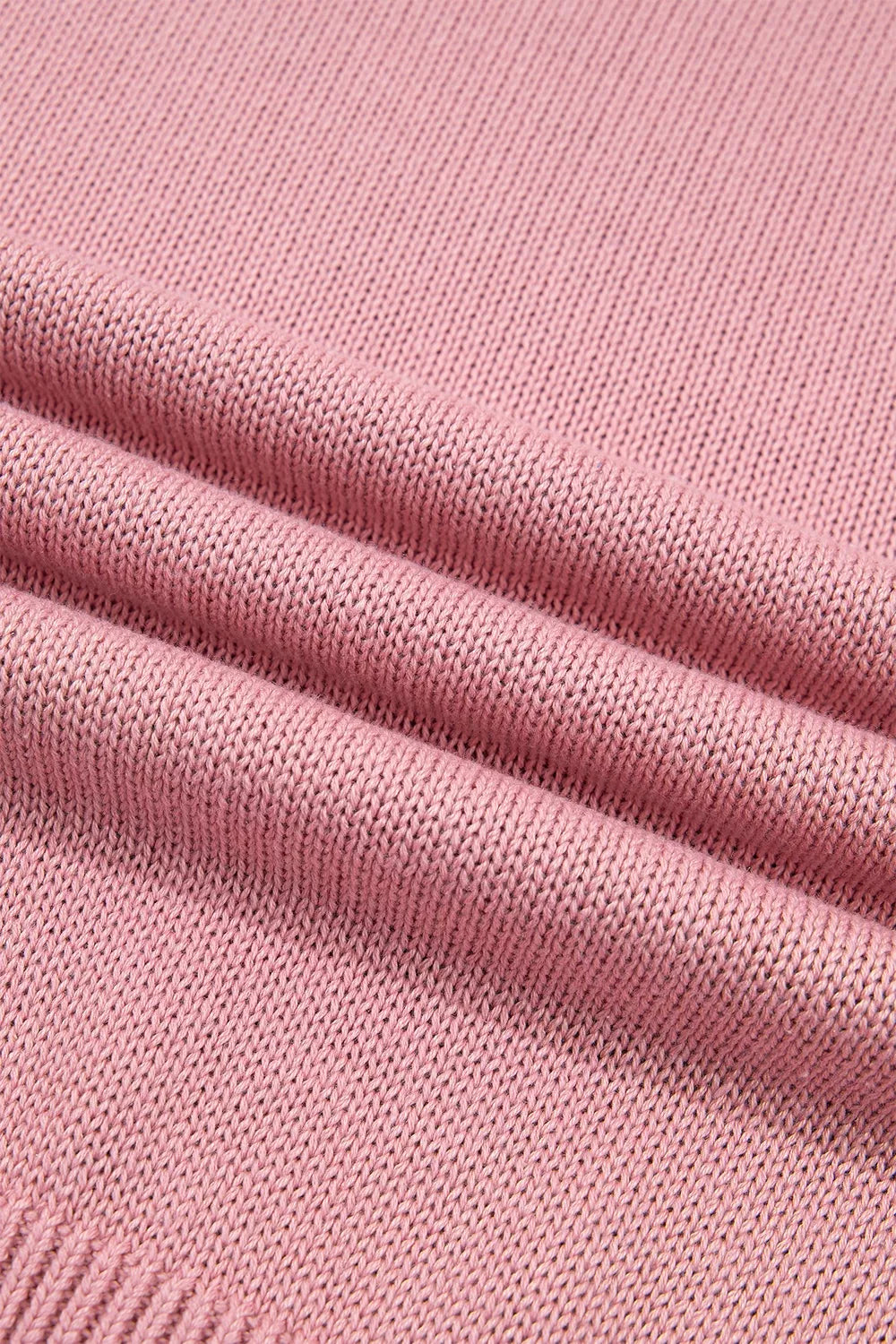 Close up of the dusty pink knit fabric showing its soft textured weave