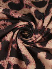 Close up swirl detail of the leopard print fabric on the bodycon midi dress