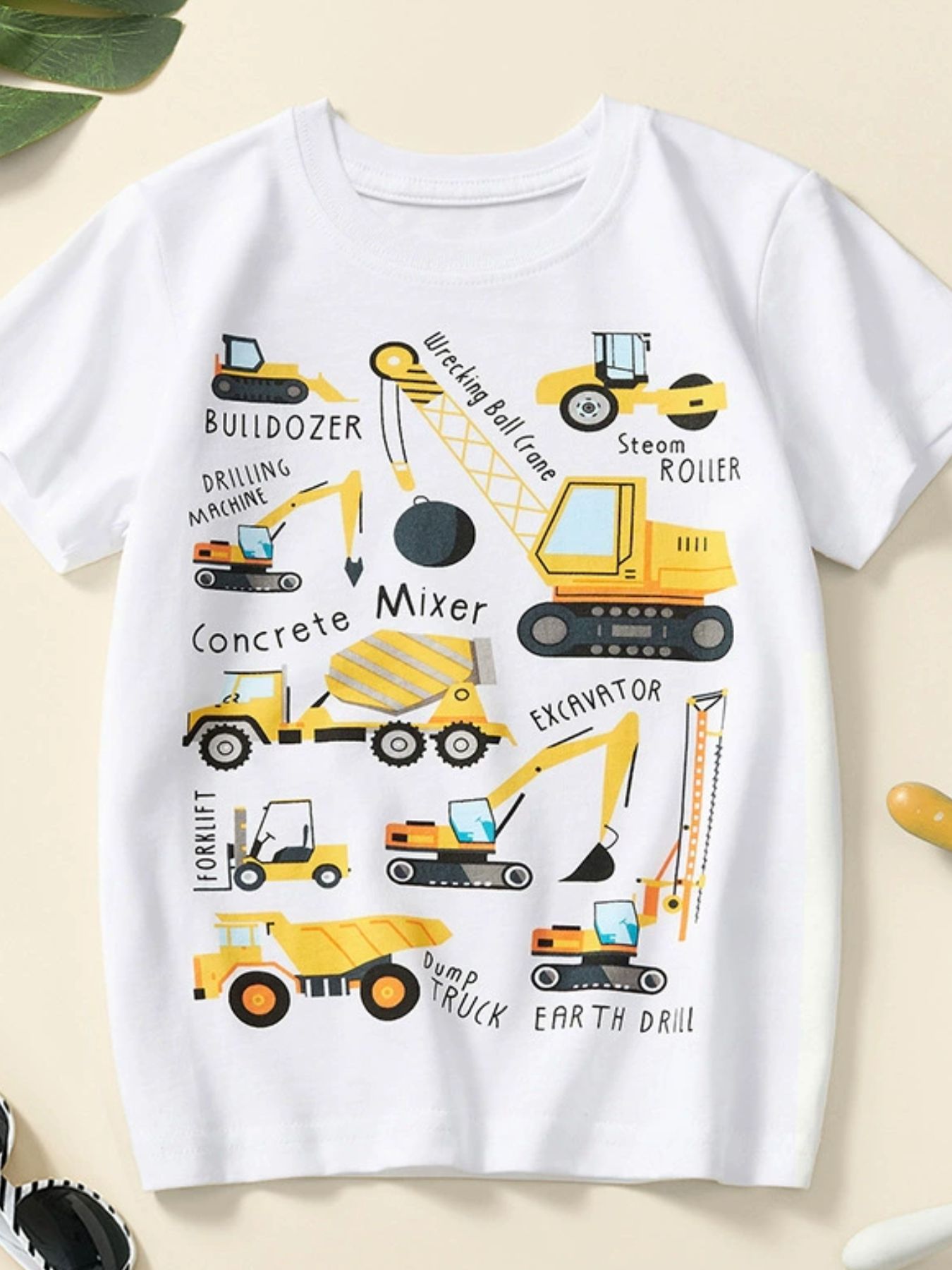 White children's crew neck short sleeve T-shirt with labeled construction vehicle graphics, laid flat in front view
