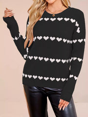 On-model front view of a black dropped shoulder sweater with rows of white hearts