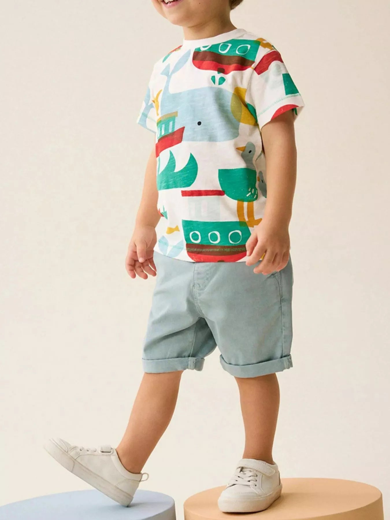 Children's white round-neck tee featuring a fish print design.