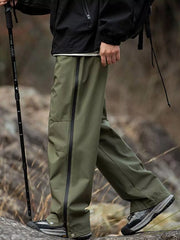 Men's olive green tactical cargo pants with multiple pockets and a drawstring waist.