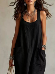 Cropped front view of black sleeveless scoop neck maxi dress, showing neckline and large pockets