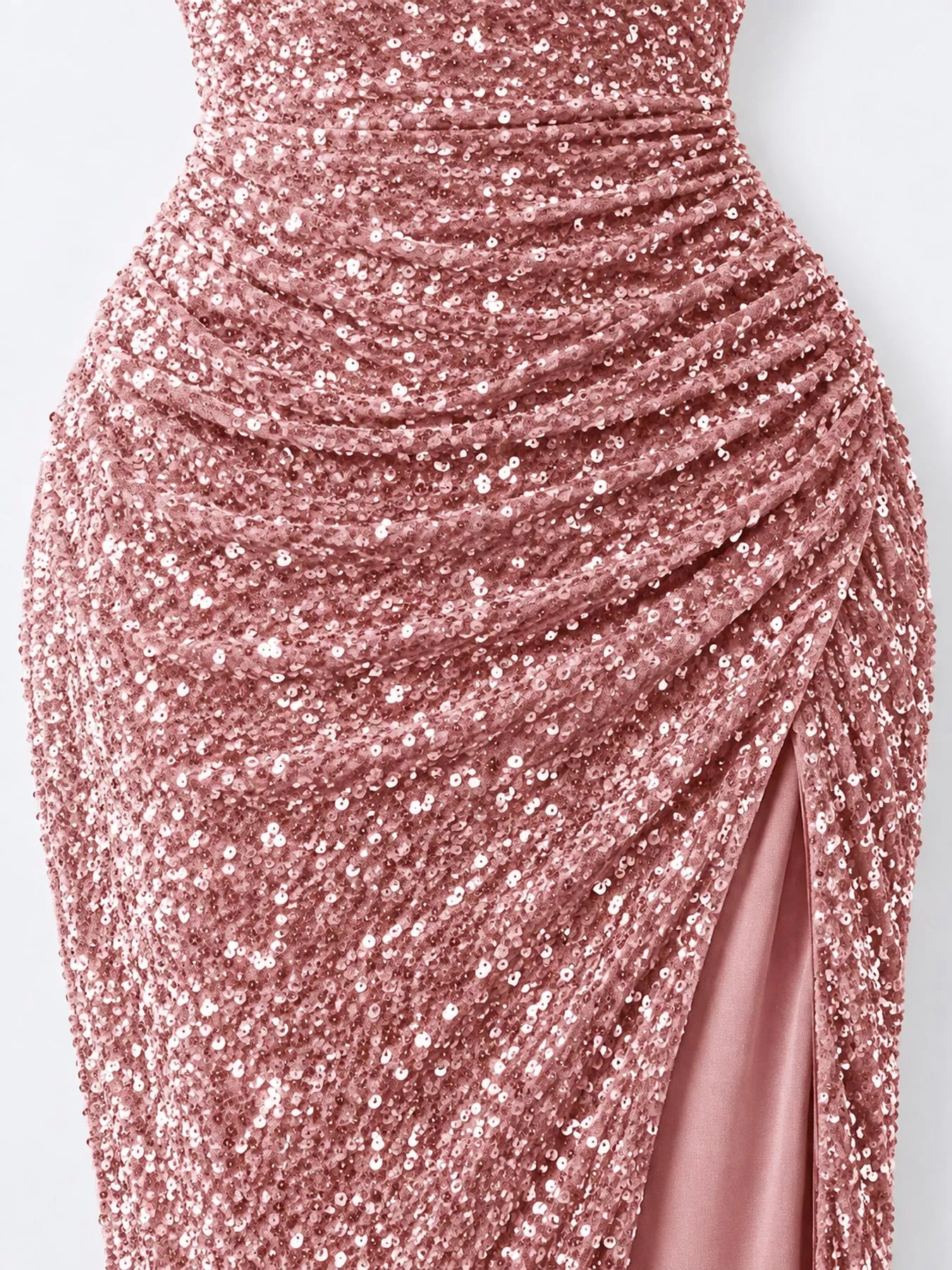 Pink sequin one shoulder evening dress close view showing the ruched waist and high slit