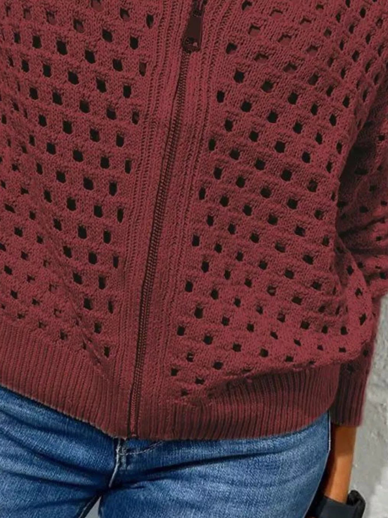 Close up of the wine red crochet cardigan lower zip and ribbed hem