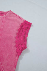Close-up detail of pink mineral-wash top featuring raw seam accents and intricate lace-trim cap sleeve