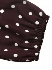 Close-up of the coffee brown polka dot bodysuit elastic sleeve cuff