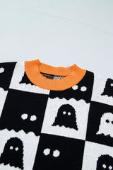 Close up of an orange ribbed neckline on a black and white ghost checkerboard sweater