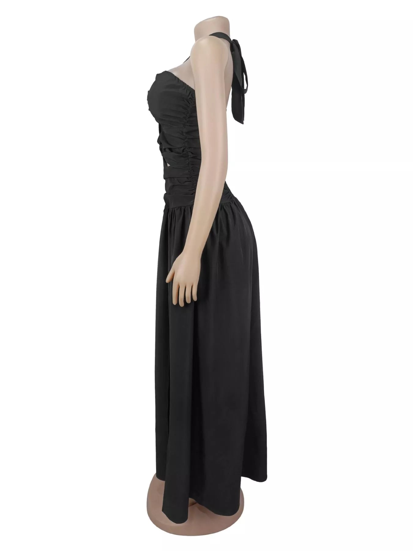Side view of black halter maxi dress on a mannequin showing ruched bodice and long skirt