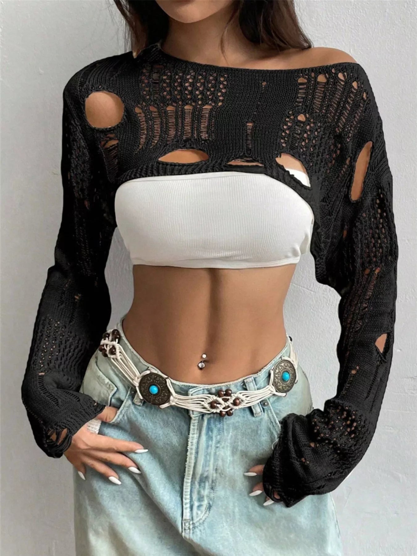 Front view of black distressed open knit cropped cover up with long sleeves.