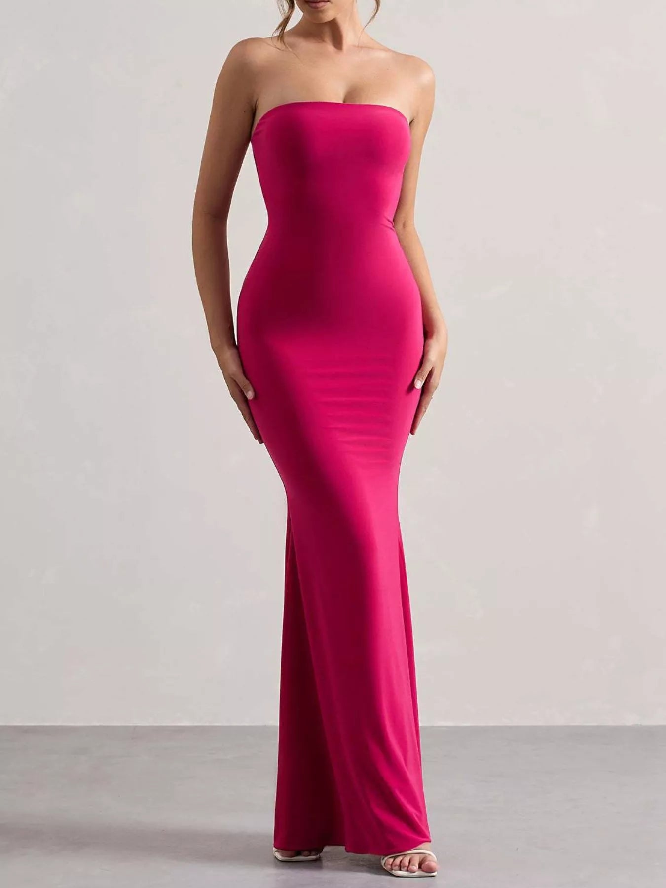 Model wearing strapless rose red tube maxi dress, front view in studio