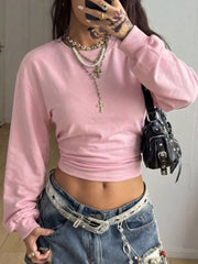 Front mirror view of pink long sleeve cropped t shirt with wide sleeves