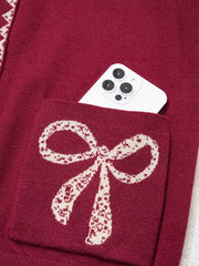 Close view of the burgundy bow pocket holding a white phone