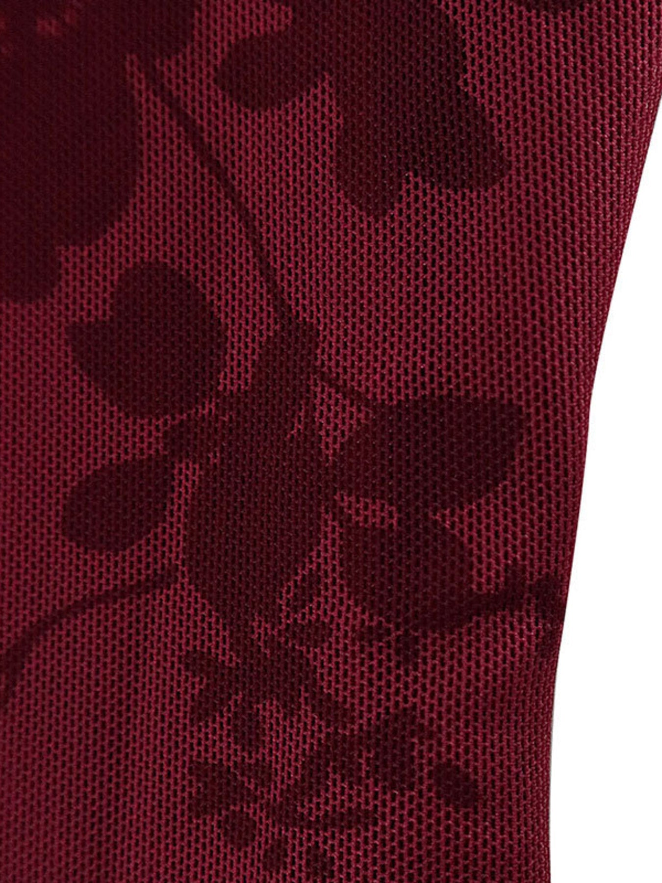 Burgundy floral mesh fabric close up showing dark floral pattern on burgundy mesh