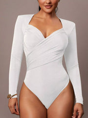 Model wearing white ruched surplice long sleeve bodysuit in front view