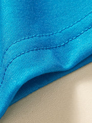 Close-up of the double-stitched hem on the sky blue children's shark tee