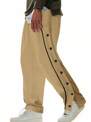Men's khaki loose-fit track pants with side snap buttons and pockets.