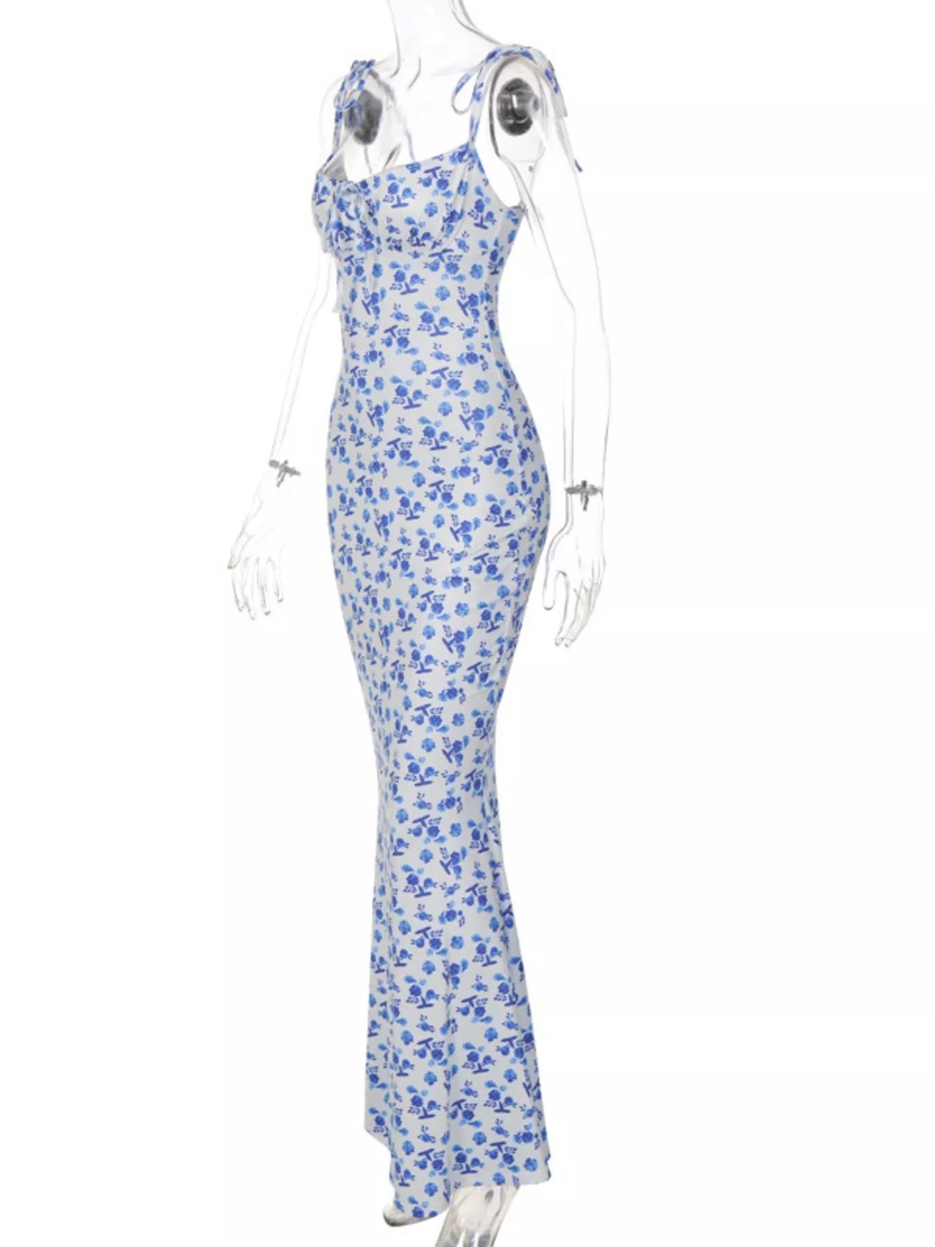 Side angle of clear mannequin wearing blue floral print bodycon maxi dress with tie straps