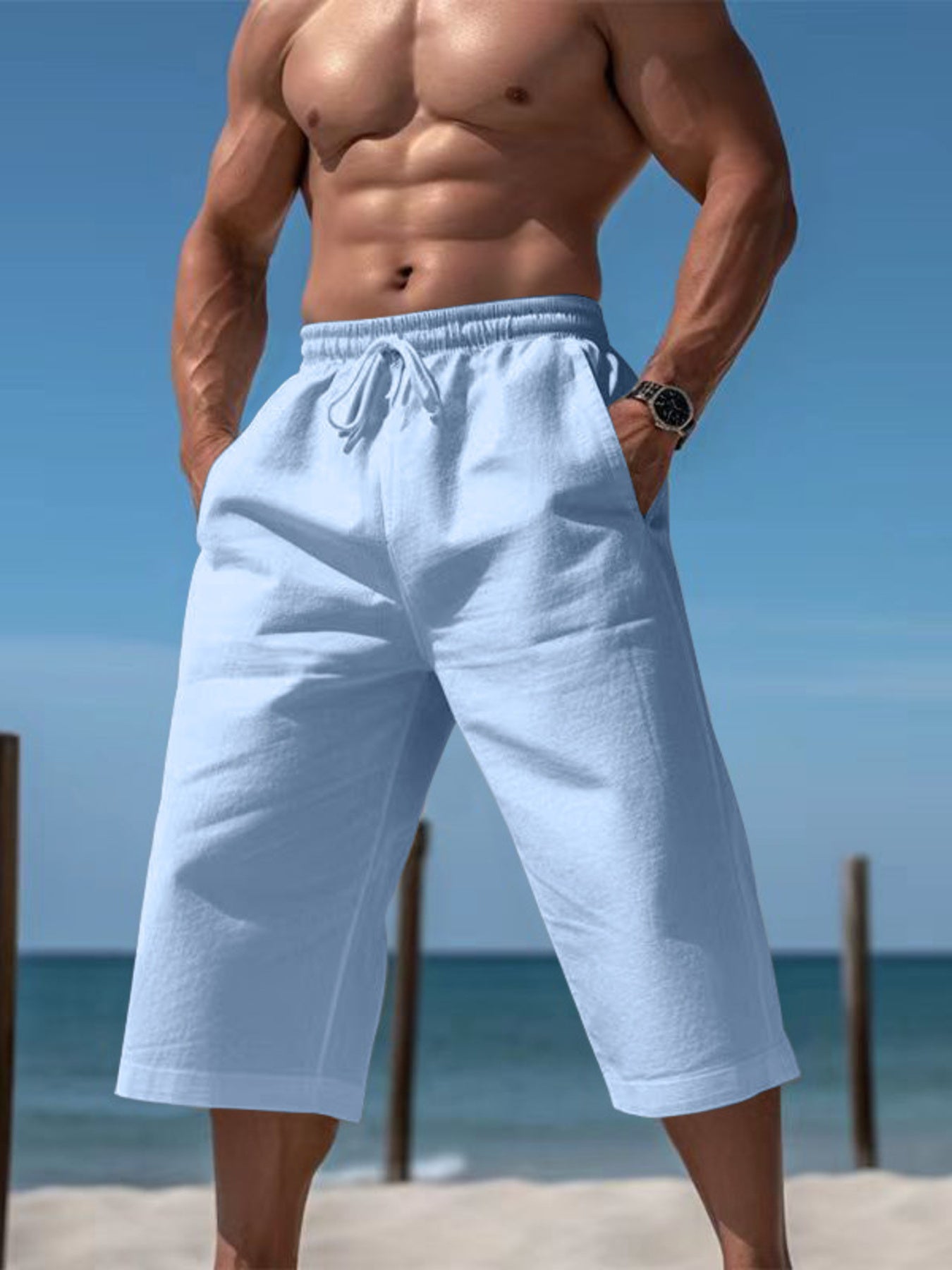 Men's light blue cropped casual pants with a drawstring waist and pockets.