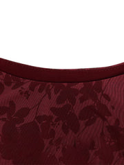 Burgundy floral mesh neckline close up showing round neck and stitching of mini dress