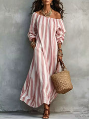Front view of pink and white striped off shoulder dress with hand in pocket